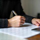 Person writing a cover letter on a laptop